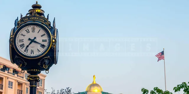 A Graceful Clock with the sign The Americana