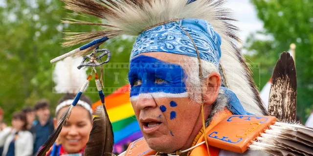 nice blue colors of face painting of a fancy dancer at pow wow