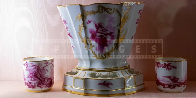 Porcelain cups and a vase with golden accents