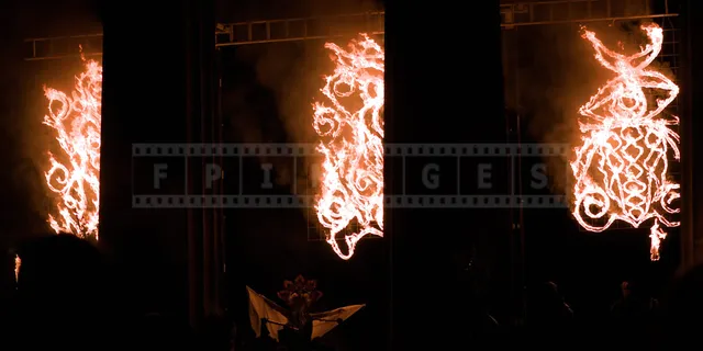 May Queen spreading her arms under the flames at the very start of the festival