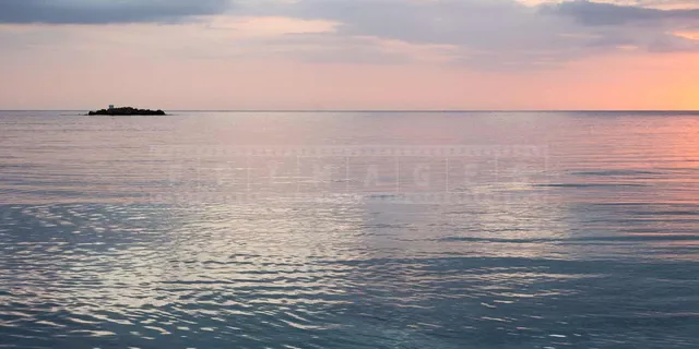 Couple watching gorgeous sunset over the Caribbean sea in Negril Jamaica