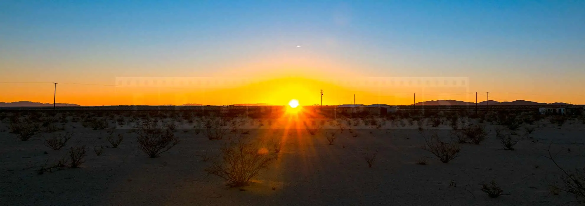 Sun rising above the horizon in the high desert of 29 Palms