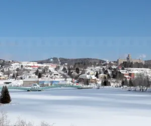 Frozen lake and snow-covered winter cityscape of Edmundston in Canada