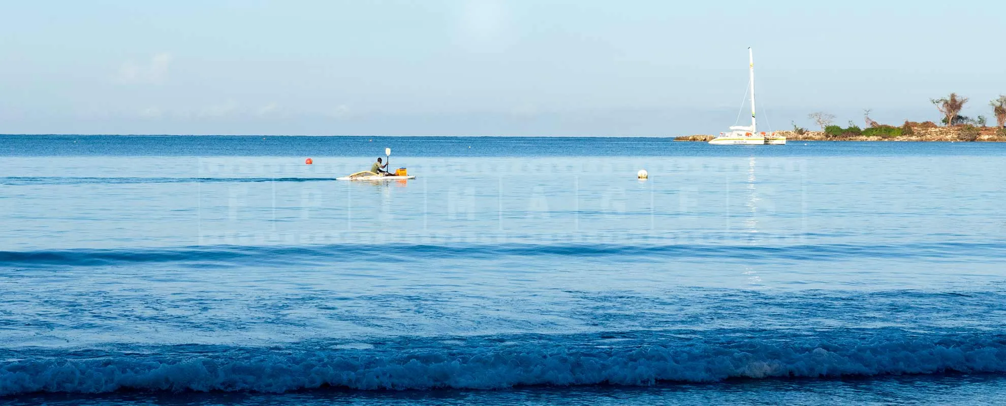 jamaica fisherman on a paddle boat