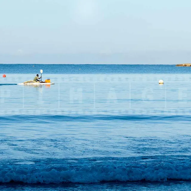 jamaica fisherman on a paddle boat