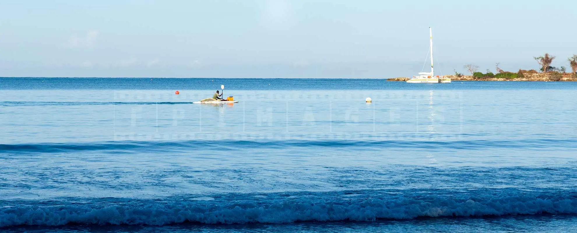 jamaica fisherman on a paddle boat