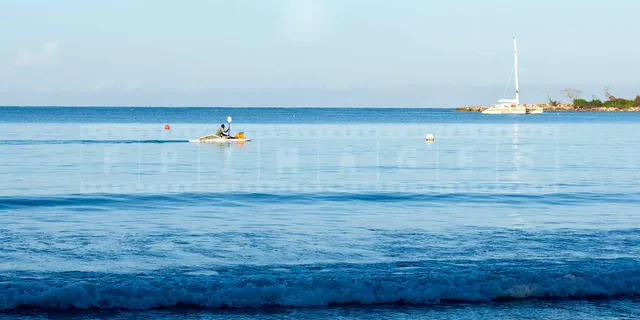 jamaica fisherman on a paddle boat