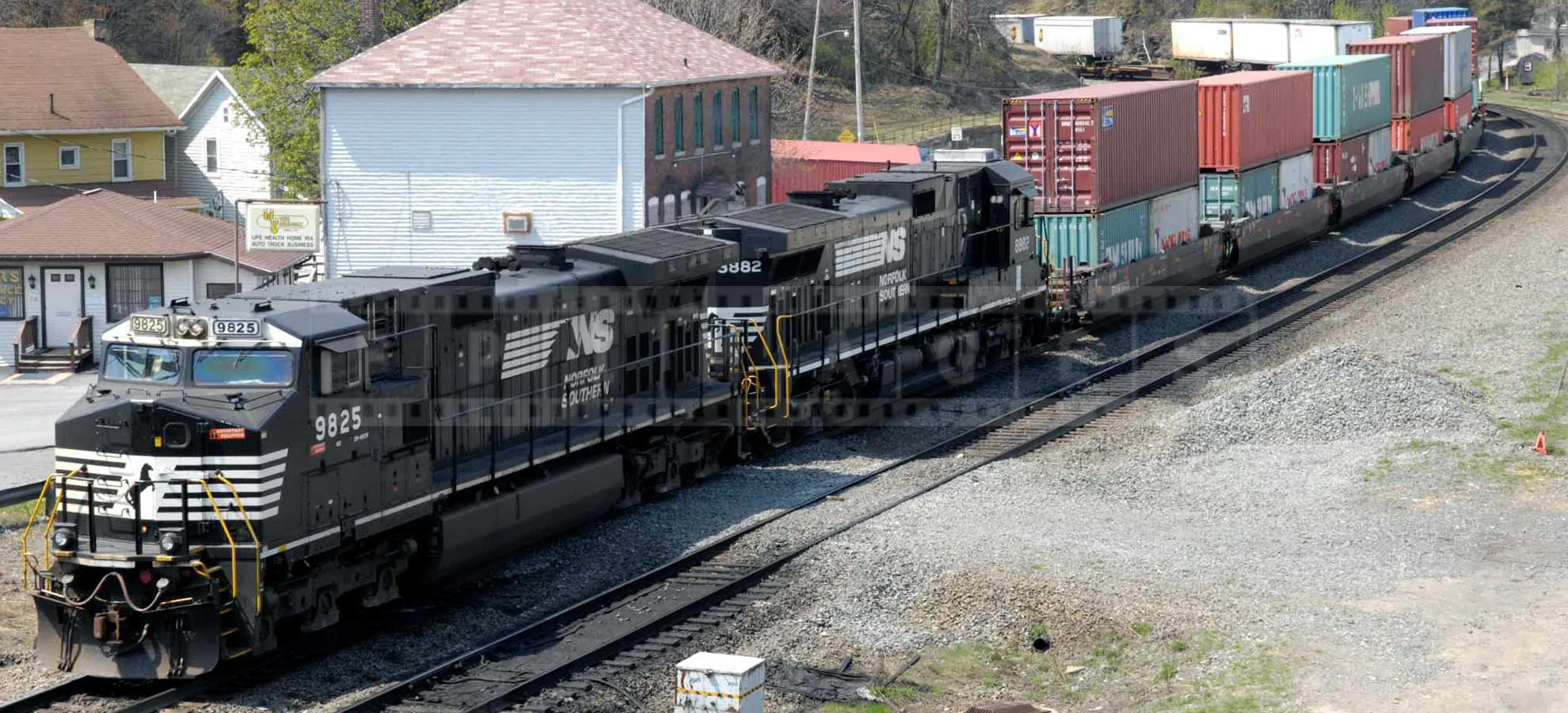 powerful train pulling a load of containers