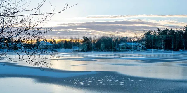Winter scene - sunrise above frozen lake in Sackville, NS, Canada