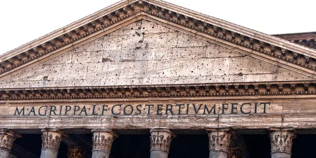 Front of the Pantheon's Portico with a sign saying Marcus Agrippa built this