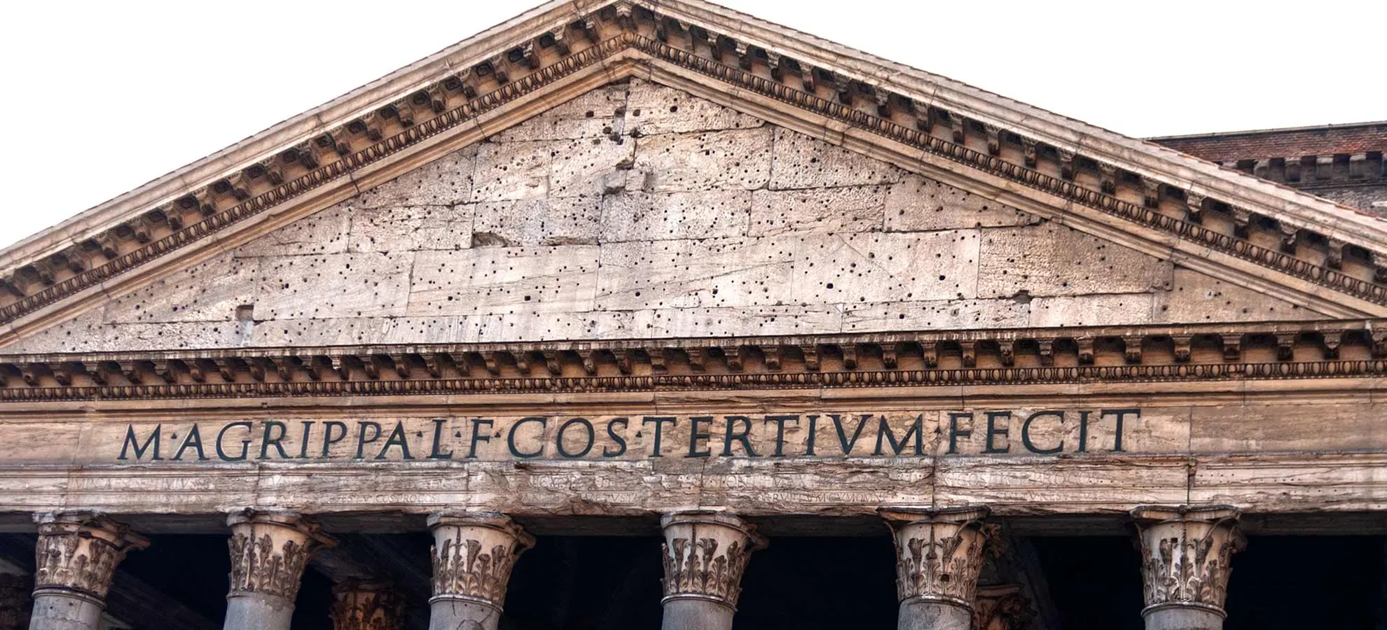 Front of the Pantheon's Portico with a sign saying Marcus Agrippa built this