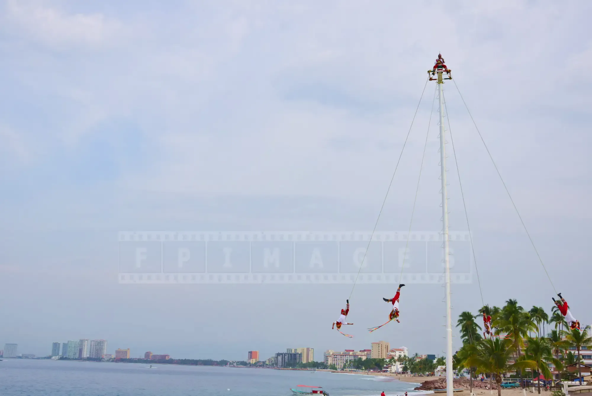 Papantla flyers performing their dance above the Malecon waterfront in Puerto Vallarta, Mexico