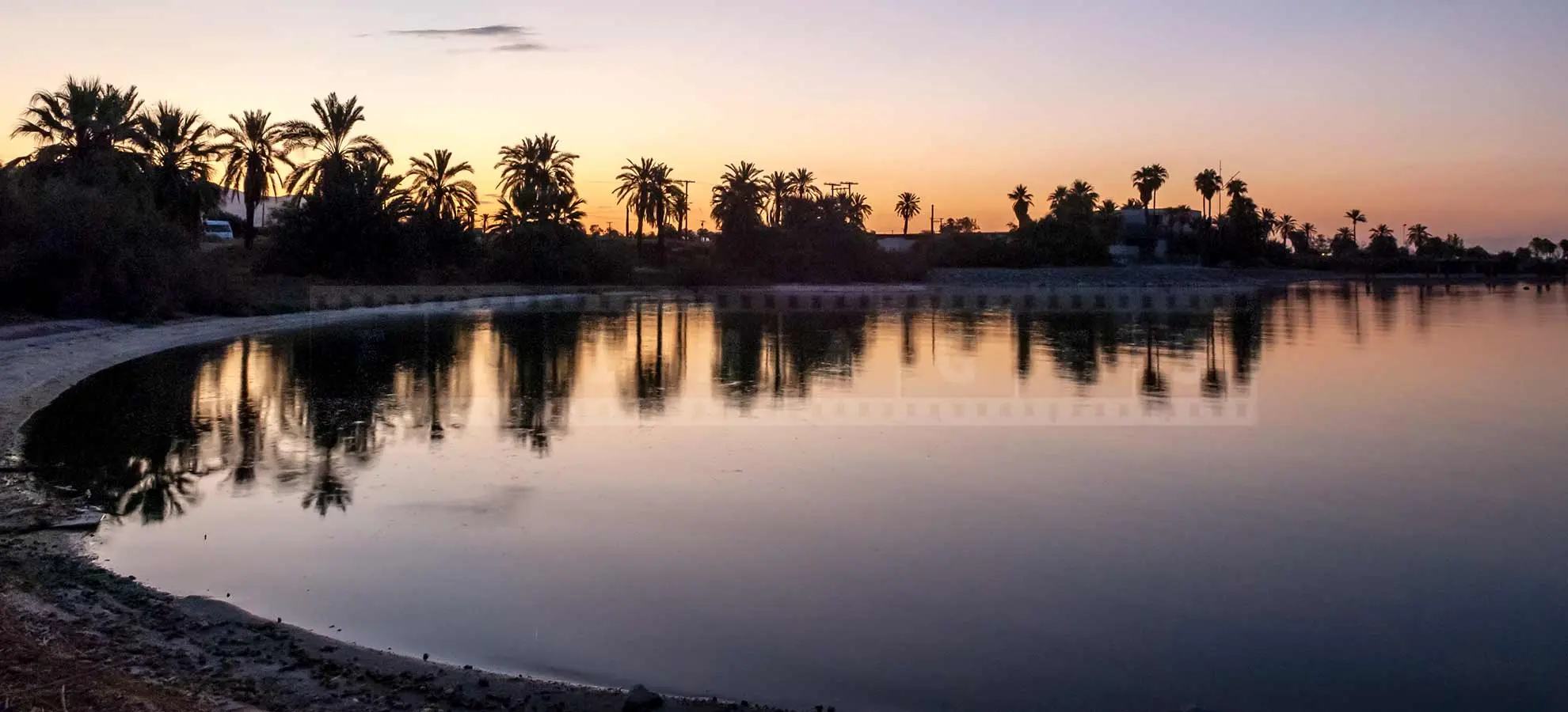 Peaceful reflections at sunrise contrast with the abandoned place