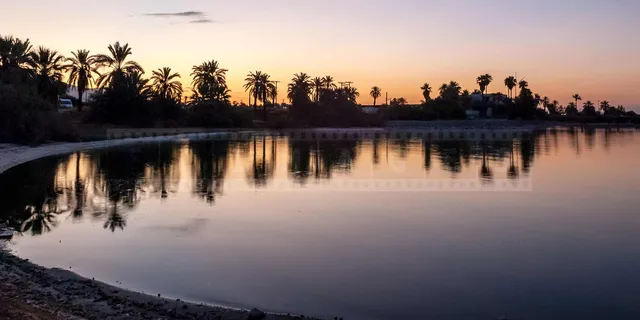 Peaceful reflections at sunrise contrast with the abandoned place