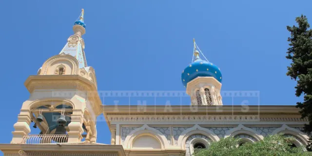 Pretty bell tower with small dome and a larger blue dome with golden stars