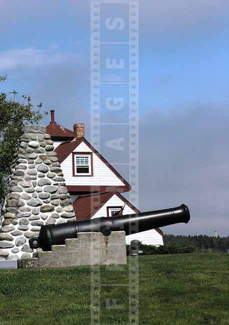 Old gun and lighthouse building picture