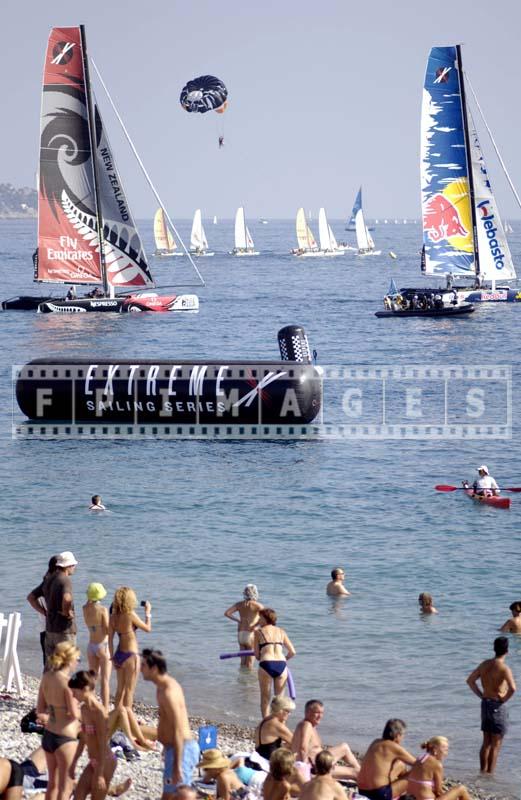 People watching race near Promenade des Anglais, colorful sailing photos.