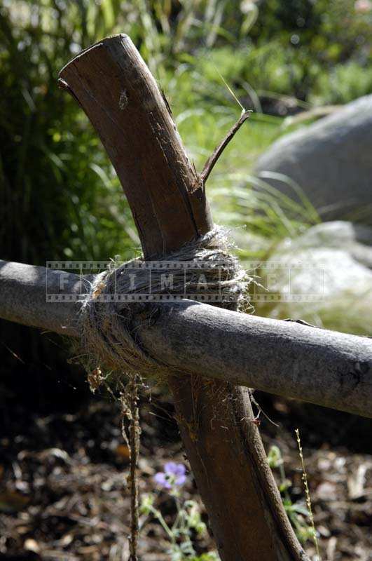 Image of a Fence Held Together by a Rope Knot