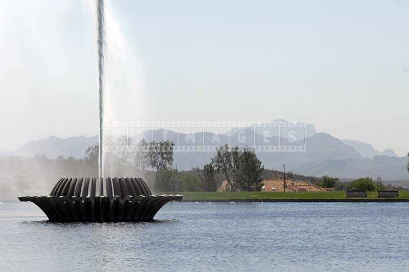 Fountain with the desert and mountains landscape as backdrop