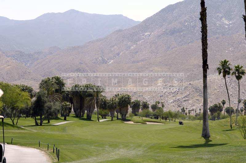 Lush Greenery of the Course against the Mountain Backdrop