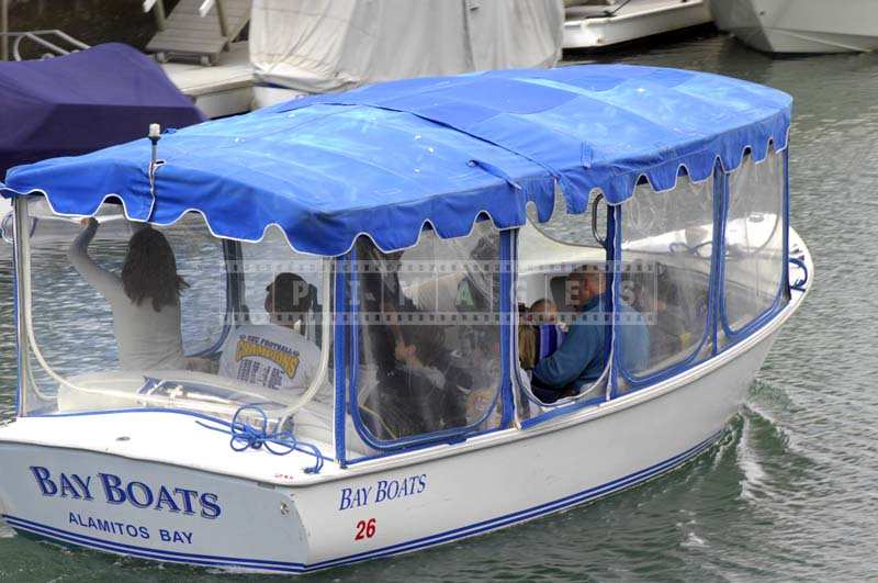 A Brightly Colored Blue and White Boat in the Canal