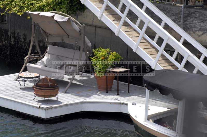 Cozy dock with a swing on the canal