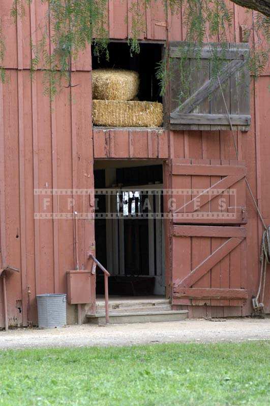 Old reddish barn with hay