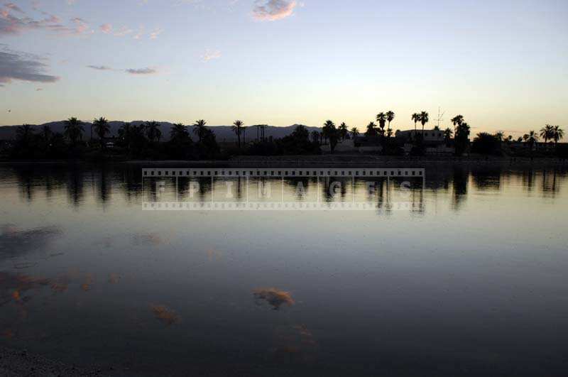 Pink clouds at sunrise reflecting in the lake