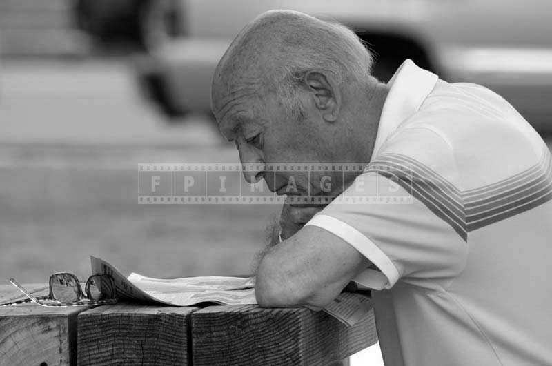 A Senior Citizen Reading Paper