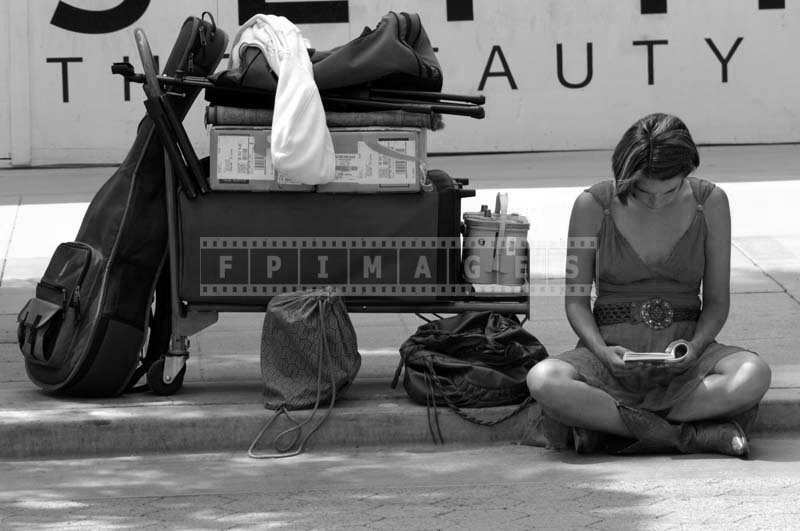 Street Performer Guitar Cases and Knapsacks on the Promenade Sidewalk