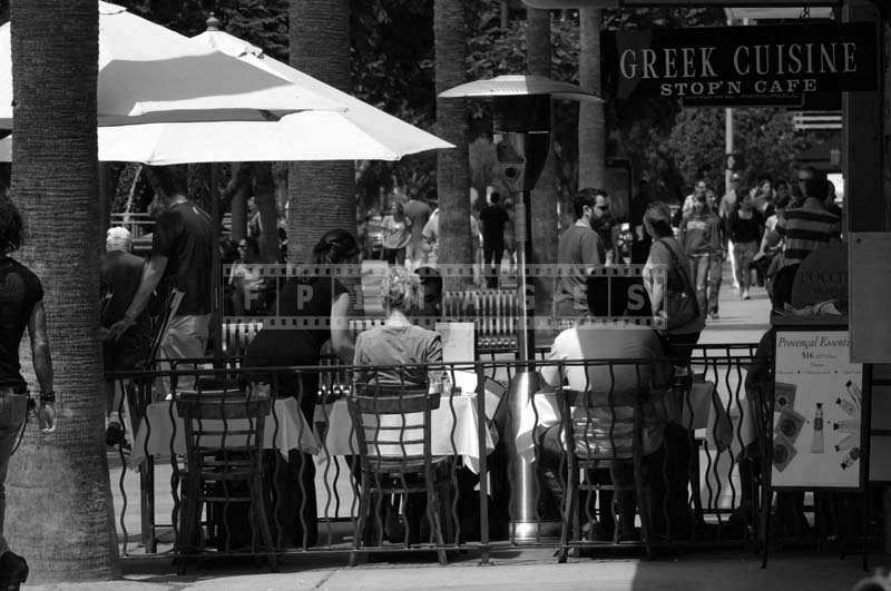 People Enjoying a Meal under the Umbrellas