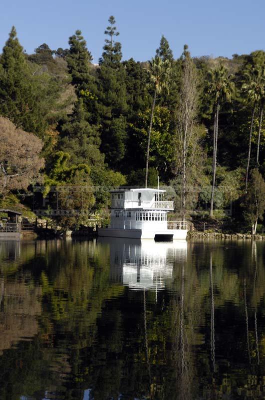 White Houseboat Reflecting in the Lake