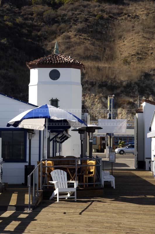 White and Blue Striped Umbrella Providing Shade at the Cafe