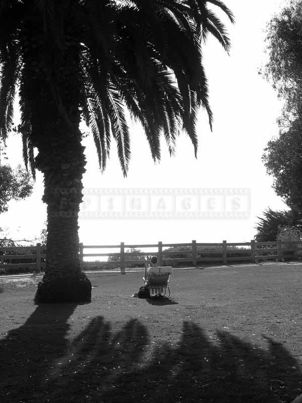 person sitting on a folding chair in the sun