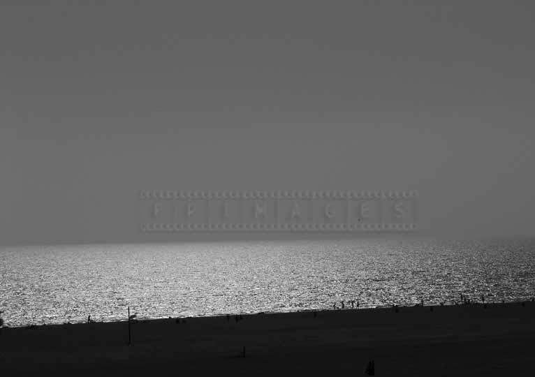 sun shining on the ocean and beach