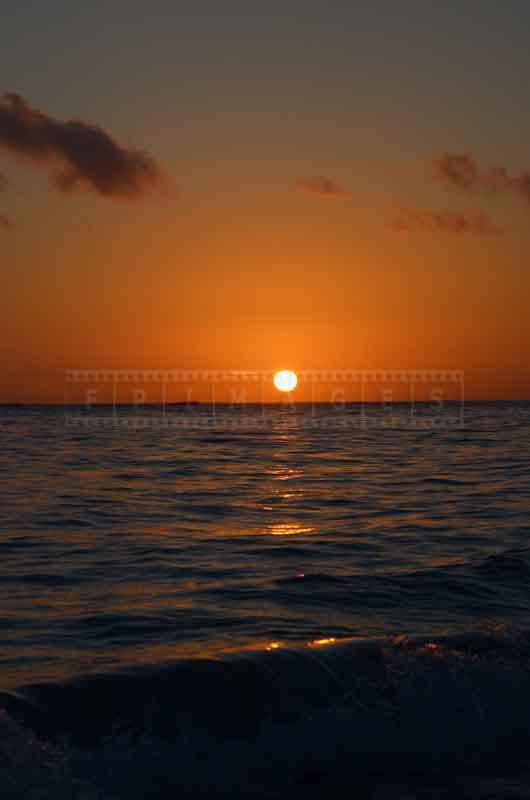 Clear skies and the sun above it at sunrise