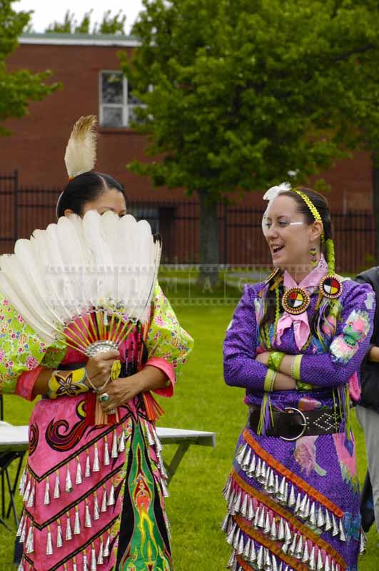 Jingle Dancers with a white feather fan