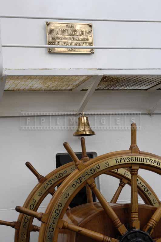 Ship construction plaque, bronze shiny bell and steering wheel