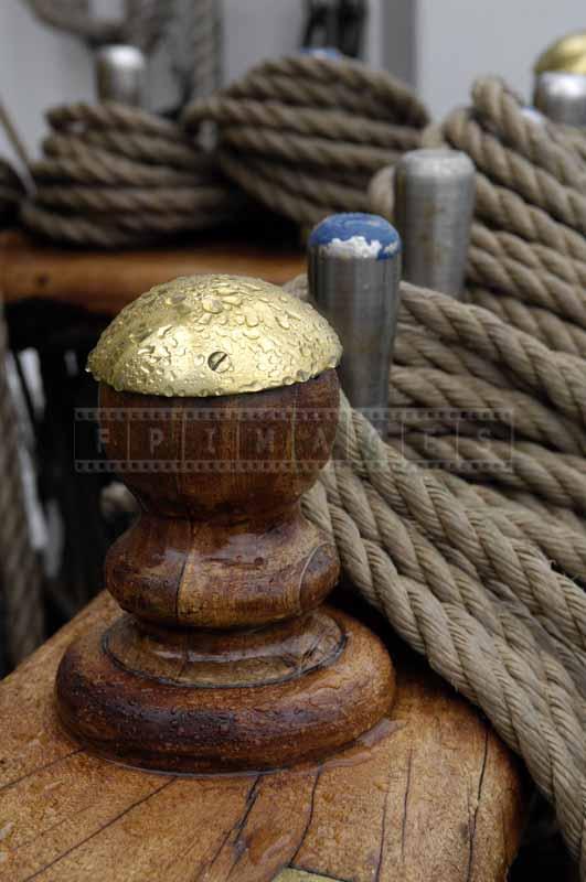 Close-up view of lines coiled on belaying pins