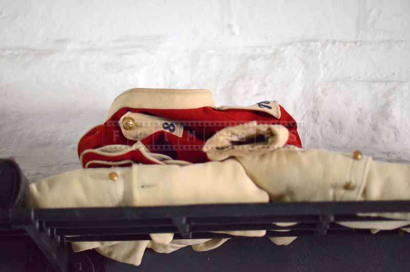 White and Red Highland Uniform on a shelf