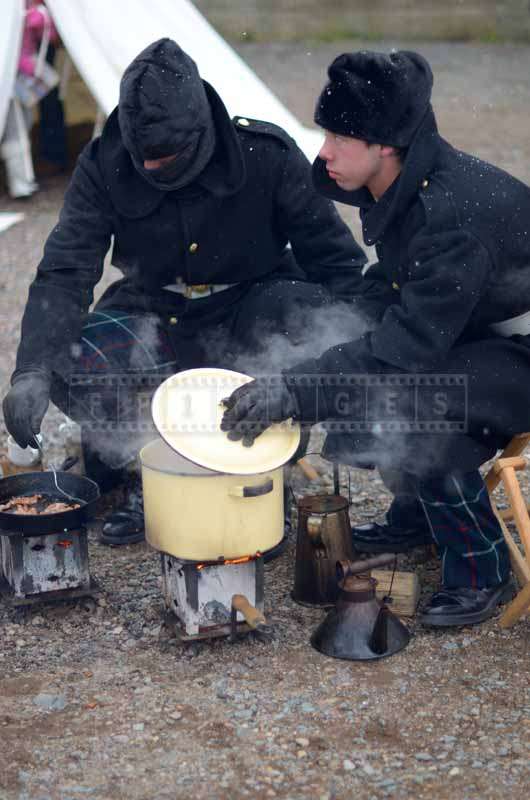 Two soldiers cooking