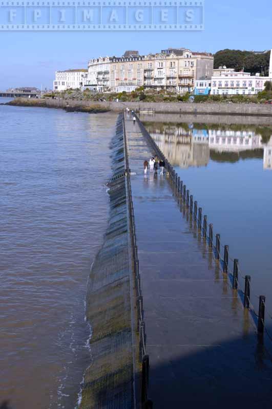 People crossing marine lake at low tide