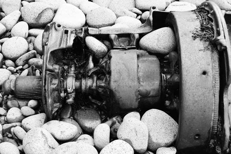 Detail of an old gear box, industrial pollution of the beach