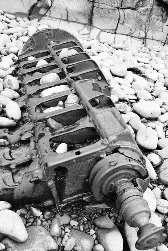 industrial images - old wrecked machine on the beach