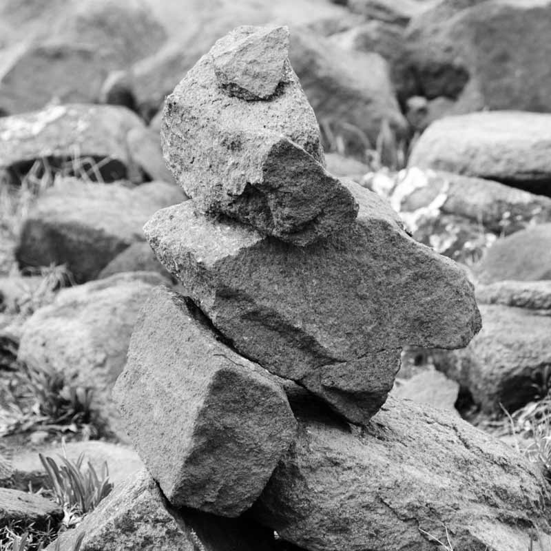 native Americans put rocks togehter to make inukshuk, abstract images