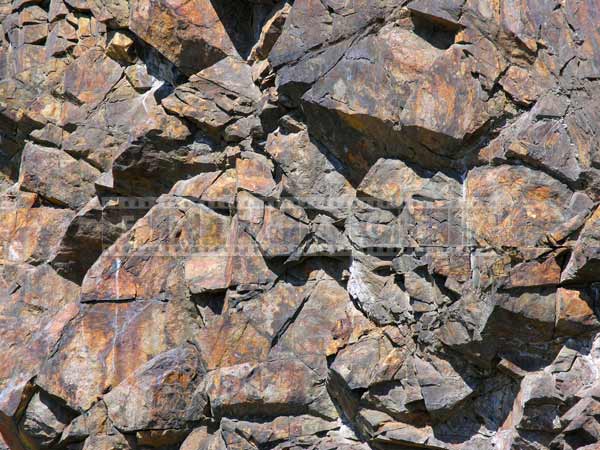 Rock texture formed by numerous polygons, strong lines, shapes and shadows