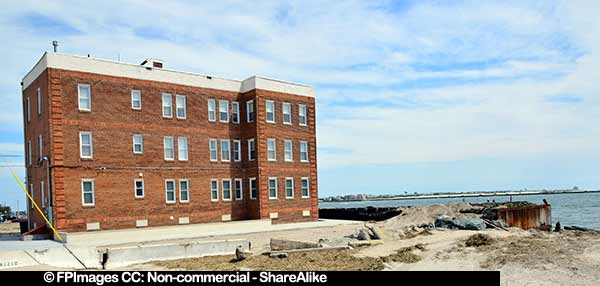 Ocean shore and boardwalk damage near residential building