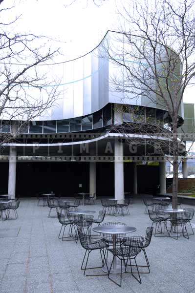 Museum of glass courtyard with cafe tables, cityscapes