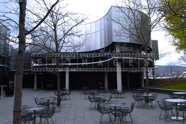 Museum of glass courtyard with cafe tables, pictures of buildings