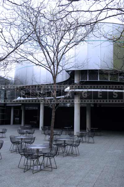 Museum of glass courtyard with cafe tables, cityscapes